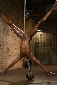 Amazing Ana submits to very strict and challenging bondage including inverted spread eagle suspension, ball tie strappado, and strict straddle spread