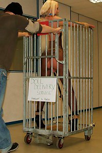 Bondage doll is put in a cage and ready for be delivered to a new owner after the auction  Submissed